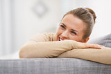 Smiling young woman sitting on couch