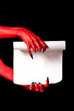 Red devil hands holding paper scroll 