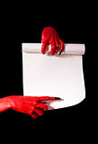 Red devil hands with black nails holding paper scroll 