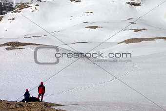 Two hikers on halt in snowy mountain