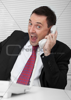 businessman screaming on the phone