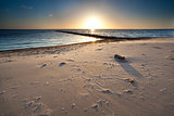 warm sunset over sand beach on North sea