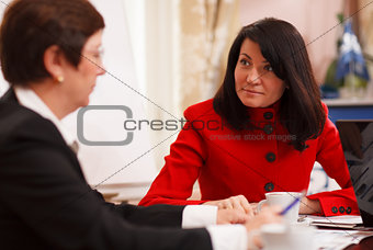 Two serious women in a business meeting