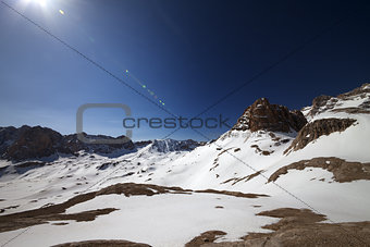 Snowy plateau and blue sky with sun
