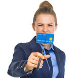 Closeup on angry business woman cutting credit card with scissor