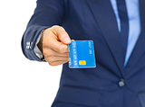 Closeup on business woman giving credit card
