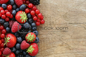 Berry fruits on a wooden board