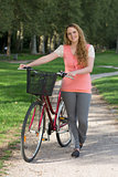 Young woman standing next to her bike