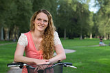 Young woman leaning against a bike