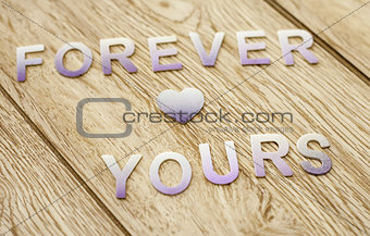 Forever yours on wooden background