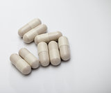 White medicine capsules on whitebackground