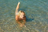 Teenage girl lying in sea water