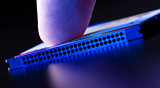 finger on flash card in blue light closeup