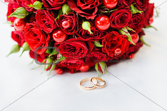 Wedding rings with a bouquet of roses