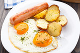 Breakfast with eggs, sausage and potato