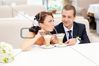 groom and bride drinking cappuccino