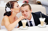 Beautiful young wedding couple  drinking cappuccino.
