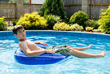 boy in the home swimming pool