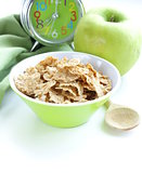 healthy breakfast - muesli and apple (alarm clock in the background)