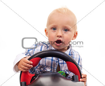 Little boy holding a toy steering wheel over white background