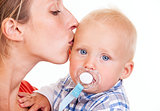 Young Caucasian woman kissing her baby son