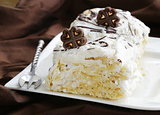 white layer cake with custard (Napoleon) decorated with chocolate