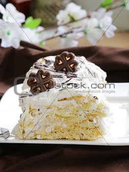 white layer cake with custard (Napoleon) decorated with chocolate