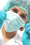 Close up of a dentist woman with a mask holding tools ready to operate