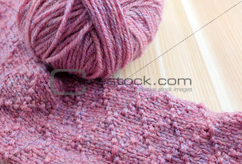 Patterned knitting with ball of pink yarn