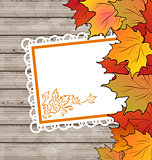 Autumn card with leaves maple, wooden texture