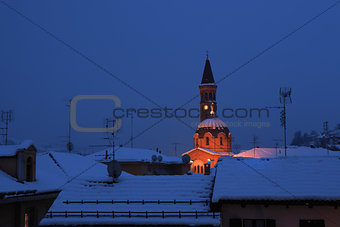 Snowy roofs and church in Alba, Italy.