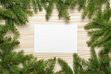 christmas background from fir twigs with postcard