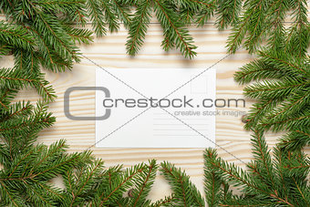 christmas background from fir twigs with postcard