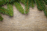 christmas background from fir twigs on wooden table