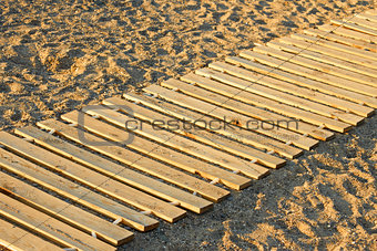 Wooden mat on a sandy beach