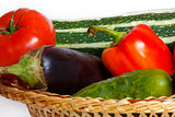 Tomato, pepper, cucumber, eggplant, squash in straw basket