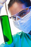 Asian Female Scientist & Green Test Tube In Laboratory 