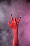Spooky devil hand showing heavy metal gesture 