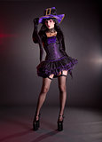 Sexy witch in purple Halloween costume  