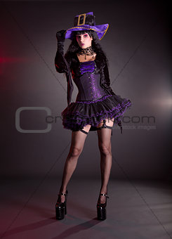 Sexy witch in purple Halloween costume  