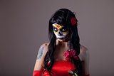 Portrait of sugar skull girl with red rose 