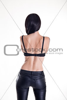 Rear view of beautiful woman wearing leather pants 