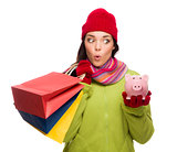 Concerned Mixed Race Woman Holding Shopping Bags and Piggybank