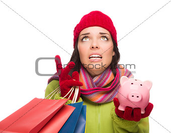 Stressed Mixed Race Woman Holding Shopping Bags and Piggybank