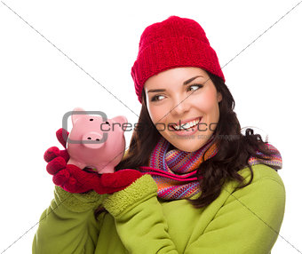 Mixed Race Woman Wearing Winter Hat Holding Piggybank on White 