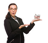 Mixed Race Businesswoman Holding Small House to the Side 