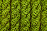 Closeup of green cable knitting stitch