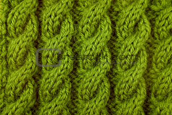 Closeup of green cable knitting stitch