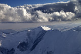 Winter mountains in evening and cloudy sky