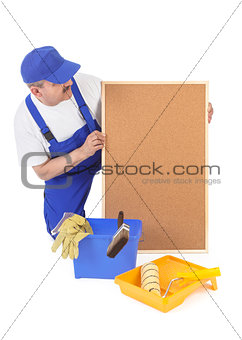 House painter and empty corkboard 